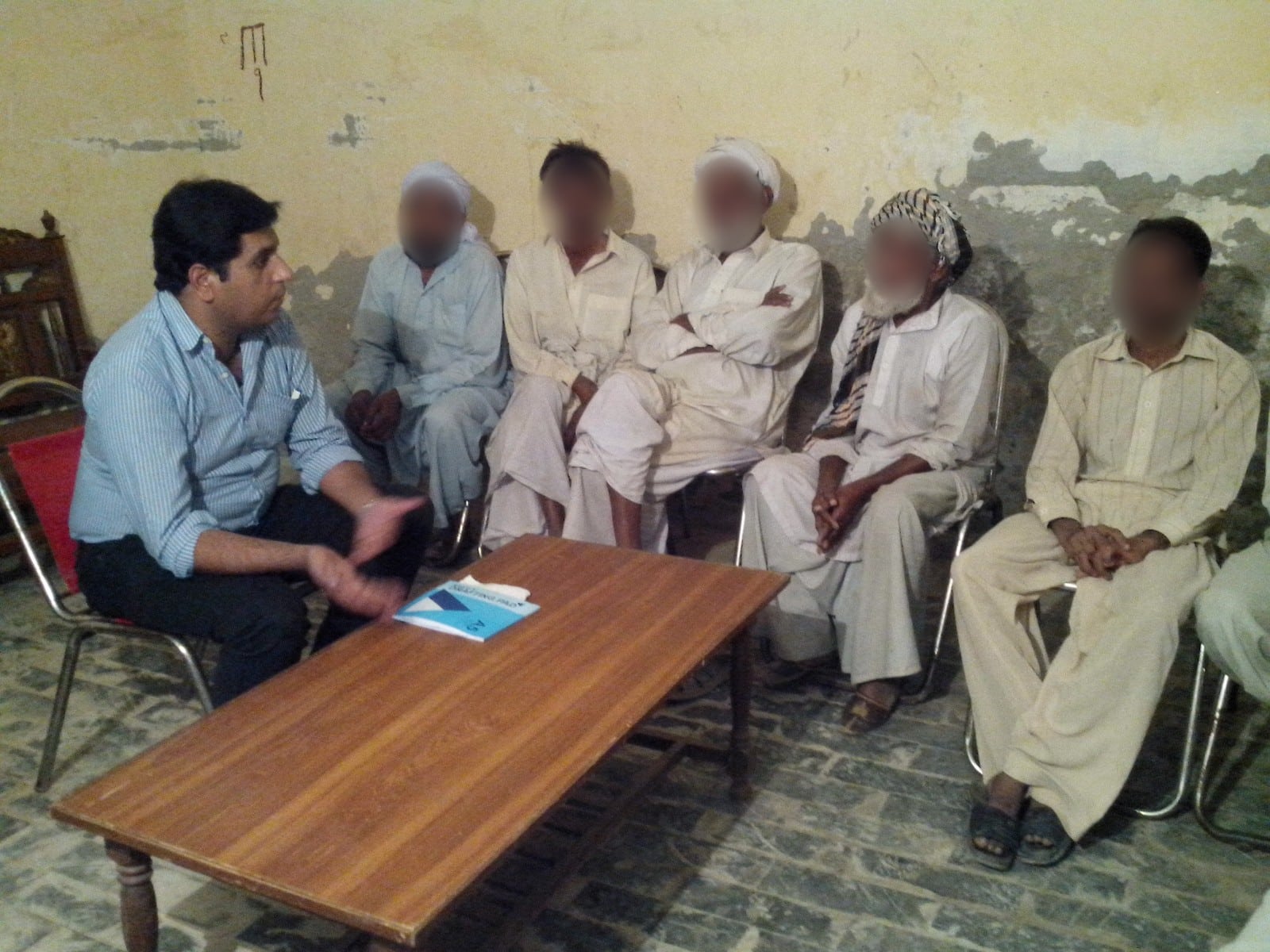 A Peace Through Prosperity needs-assessment meeting with men in Bahawalpur, Punjab, 2013. Faces blurred.