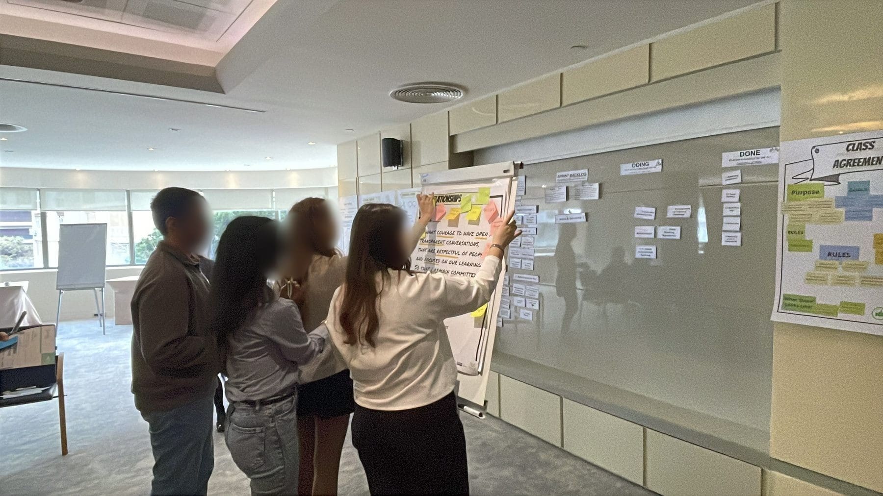 Students mapping a system on a wall canvas at the Numu bootcamp in Izmir, Türkiye