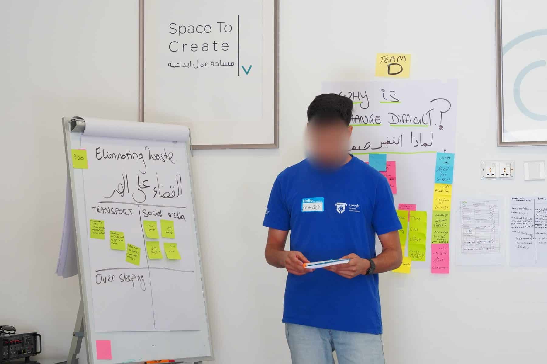 A participant in Numu's agile training for young leaders, presenting a bilingual Arabic and English team canvas in Amman, Jordan