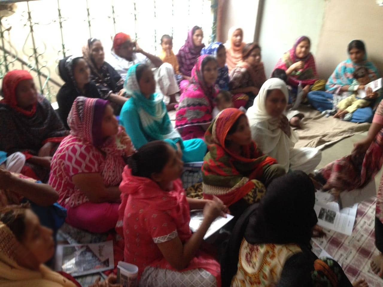 Women micro-entrepreneurs working through a mini-MBA exercise in Karachi, 2016. Faces blurred.