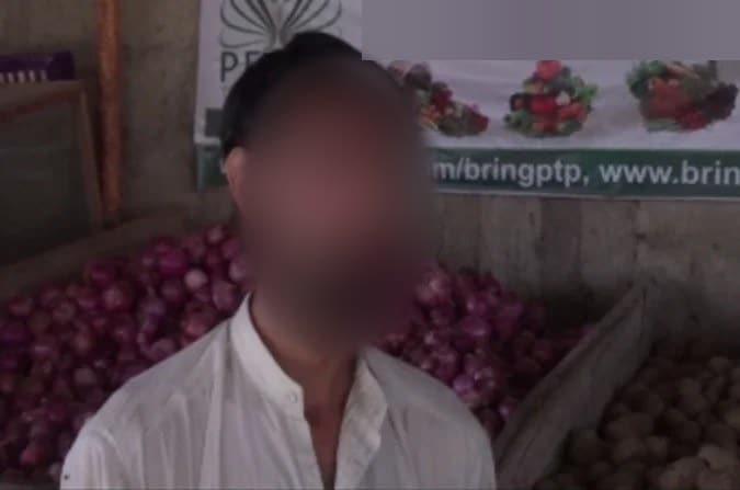 A mini-MBA participant at his vegetable stall in Karachi, with the shop name on the banner blurred for privacy